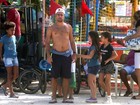 Sem camisa, Roger Flores passeia com crianças no Rio