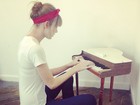 Taylor Swift se diverte tocando piano de brinquedo