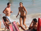 De biquíni de oncinha, Alice Dellal vai à praia no Rio 
