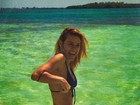Carolina Dieckmann aproveita dia em praia e impressiona com cinturinha