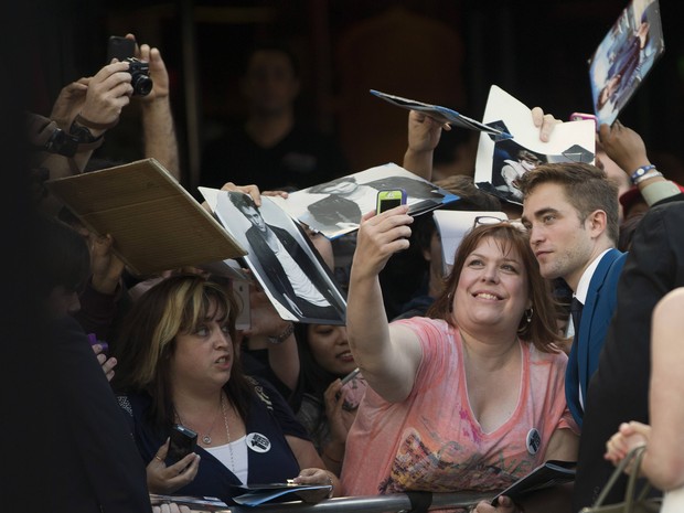 Robert Pattinson tira foto com fã em première de filme em Los Angeles, nos Estados Unidos (Foto: Mario Anzuoni/ Reuters)