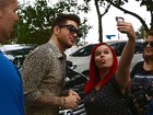 Adam Lambert atende fãs em porta de hotel no Rio