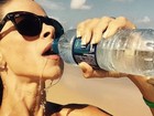 Dany Bananinha sensualiza ao beber água na praia