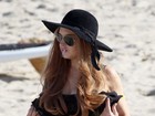 Lindsay Lohan fuma na praia e ganha massagem de uma amiga 